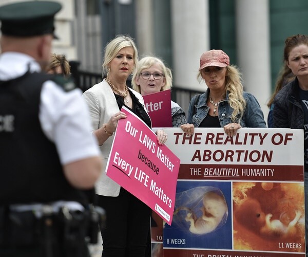 abortion protesters holding signs in ireland