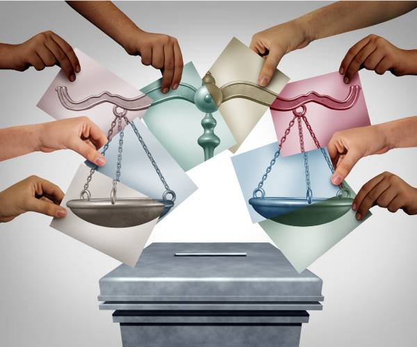 illustration of hands casting ballots over scales of justice