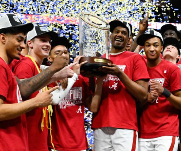 players holding up a crystal trophy as confetti falls