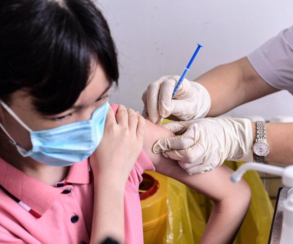 A student receives the Sinovac COVID-19 vaccine.