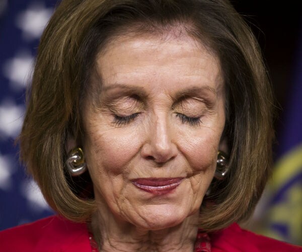 house speaker nancy pelosi is shown with her eyes closed, visably shaken,  wearing a red suit and white blouse