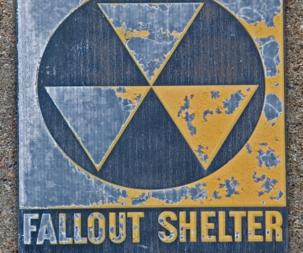 ancient weathered fallout shelter sign on abandoned cold war weapons bunker 