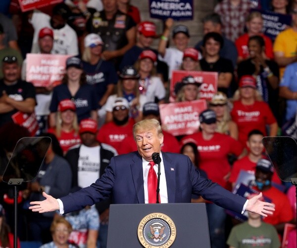 trump holds a rally in tulsa in june with a crowd of supporters behind him