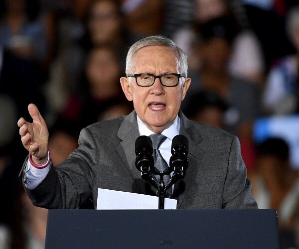harry reid speaks into mic onstage