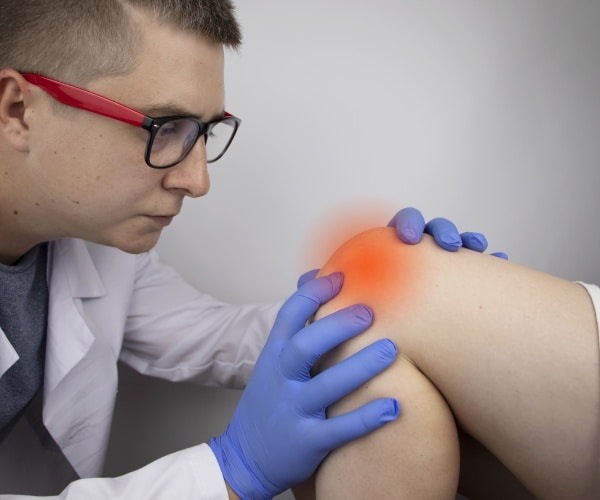 Doctor examining patient's knee