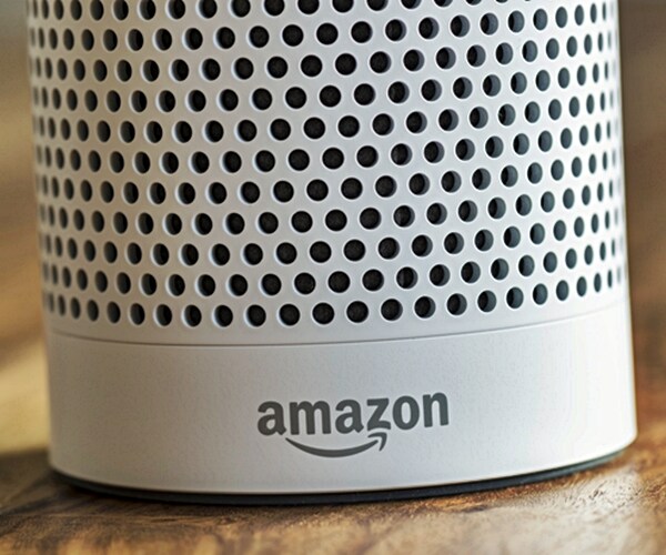 White Amazon Echo Plus, Alexa Voice Service activated recognition system photographed on wooden table