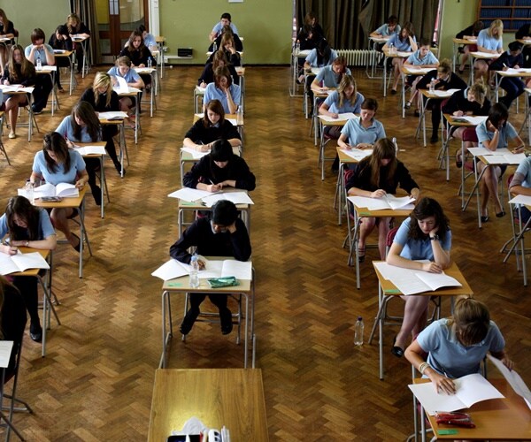 students take tests in a large exam room
