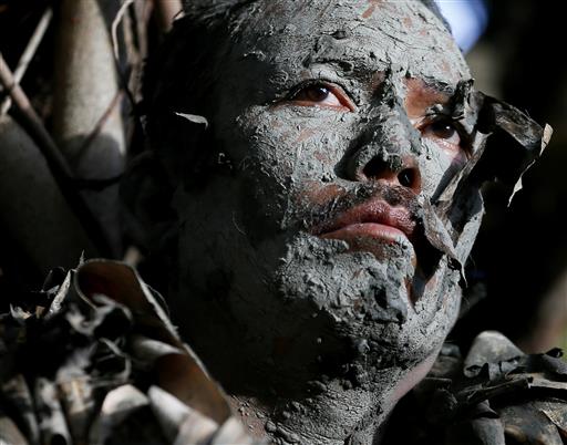 Mud-splattered Filipinos Pray to Saint for Blessing and Woes