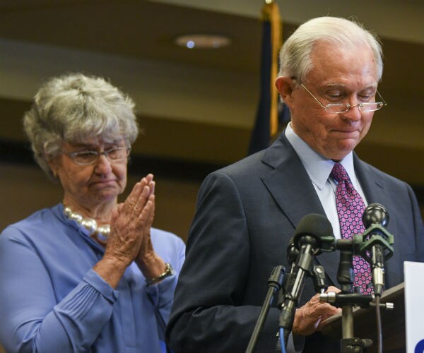 jeff sessions, in gray suit, gives a concession speech next to wife mary, wearing oversized pearls and a blue dress suit