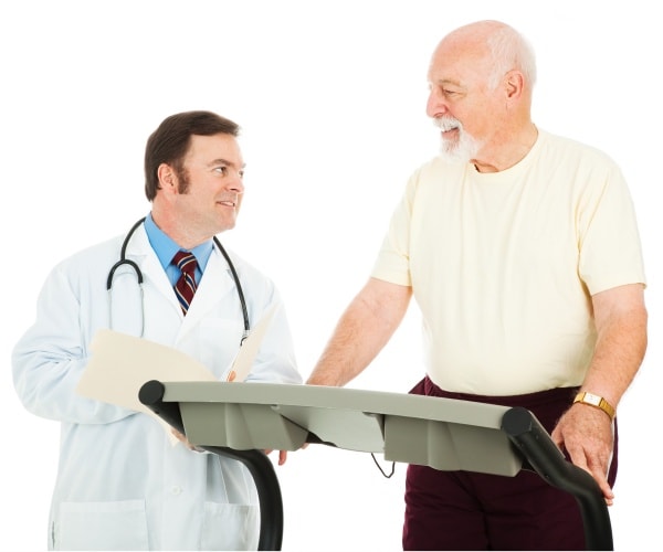 man walking on treadmill while doctor looks on