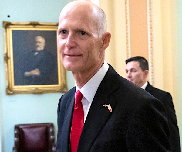 rick scott walks through the white house