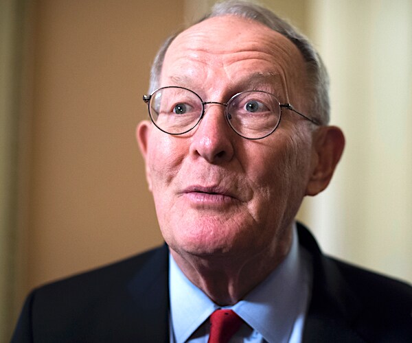 lamar alexander looks up as he speaks to the media