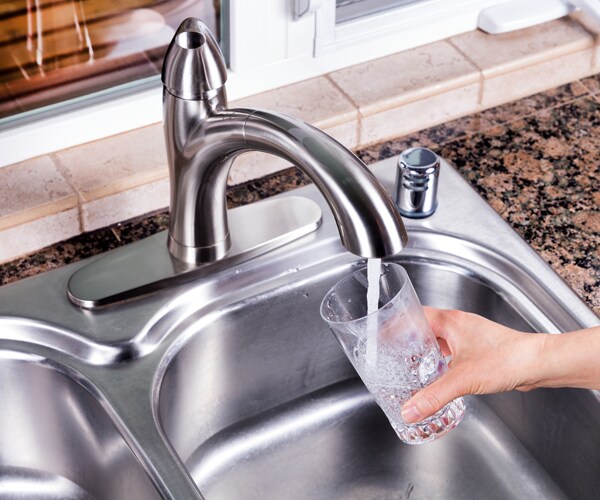Filling a glass with tap water