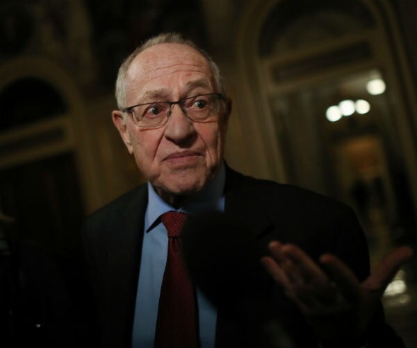 alan dershowitz is shown speaking to a reporter