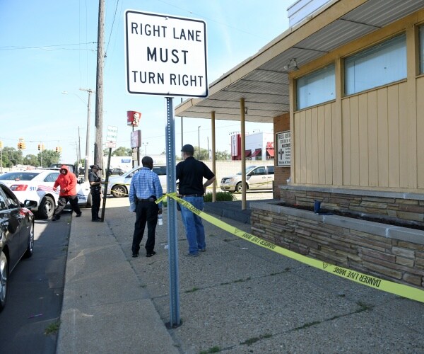 detroit police and investigators at a homicide scene