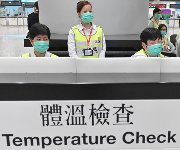 health officials in china wear face masks
