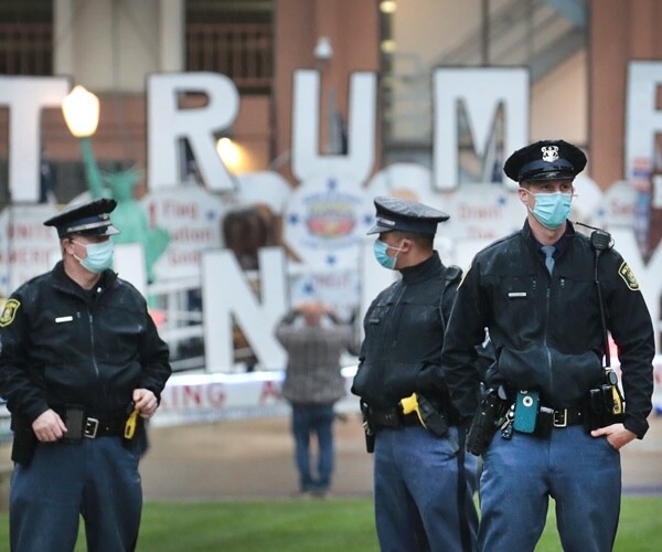 state troopers in masks guard the state capital in lansing.