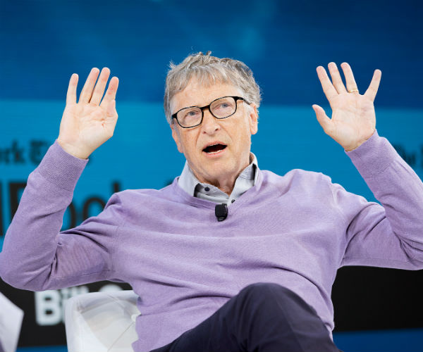 bill gates is shown in a purple v-neck sweater