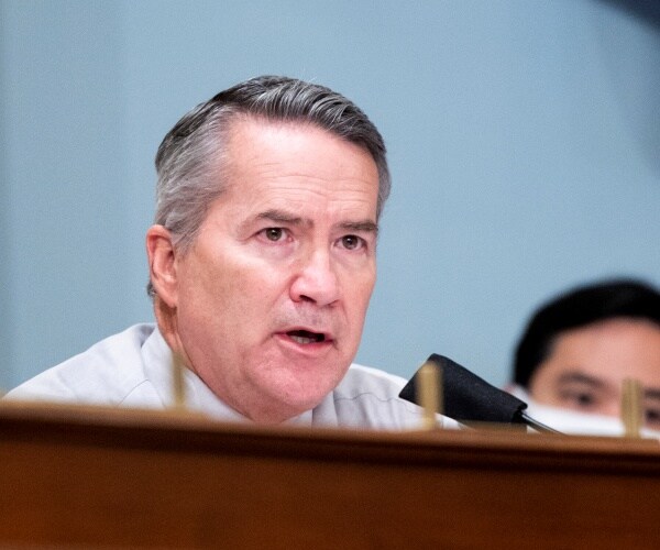 jody hice sitting behind a wood desk