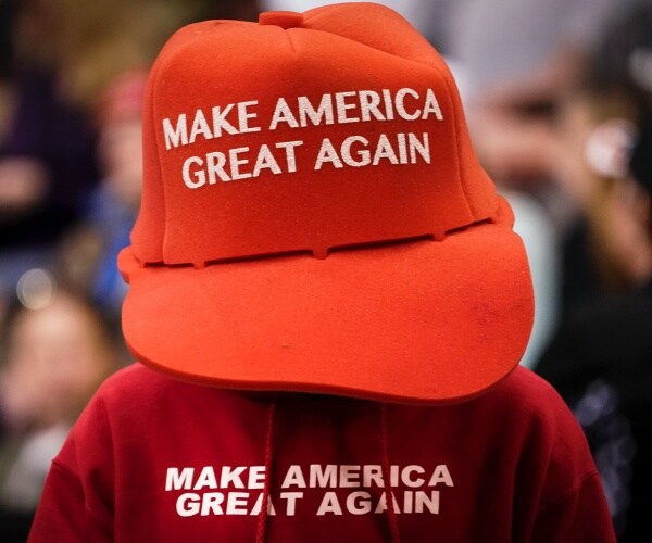 person in MAGA hat and sweatshirt