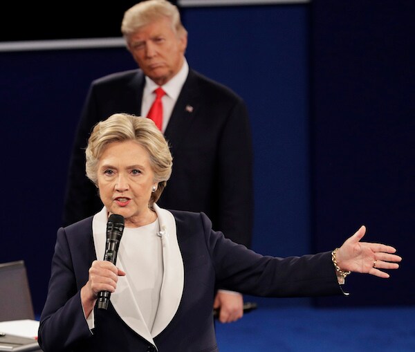Hillary Clinton speaks during a 2016 debate as President Donald Trump incredulously looks on