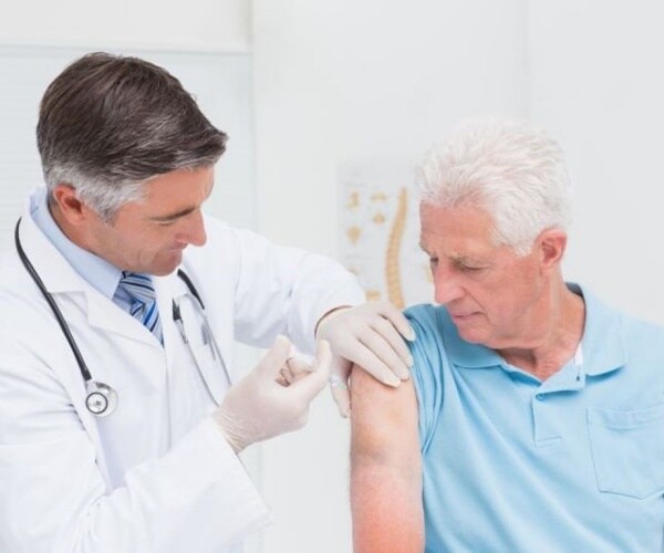 older man getting his flu shot