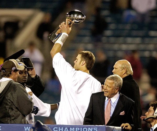 Tom Brady holding the Lombardi trophy after winning the Super Bowl with the Patriots