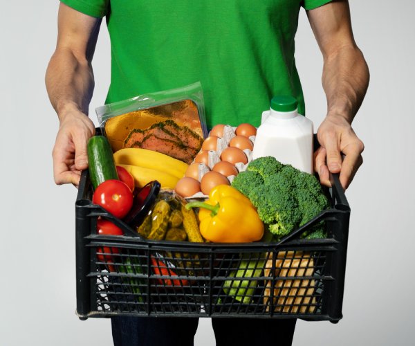 man holding grocery basket