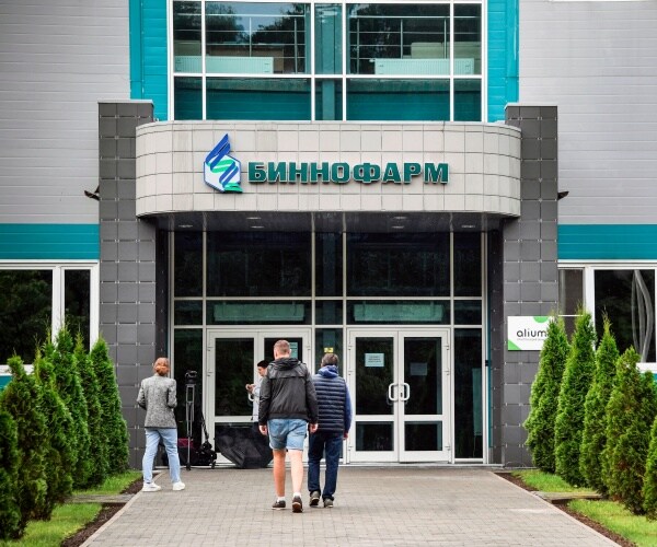 russian pharmaceutical factory with people walking inside the building