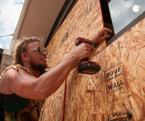 A man boards up windows ahead of Tropical Storm Barry's landfall