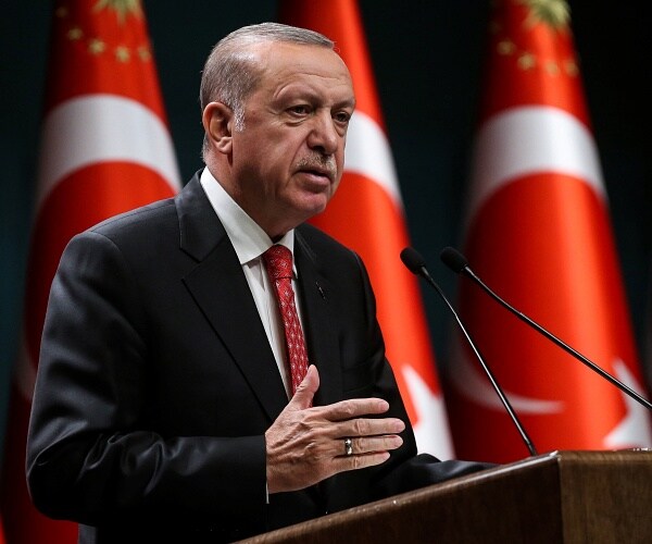recep tayyip erdogan speaks from behind podium