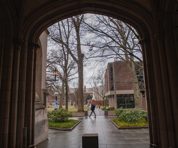 student walks through a college campus