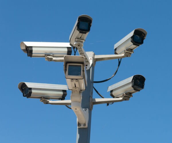 surveillance cameras suspended atop a pole 