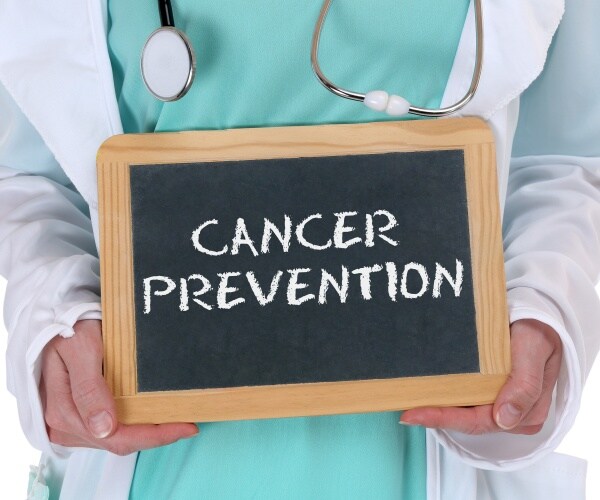 doctor holding sign that says  "cancer prevention"