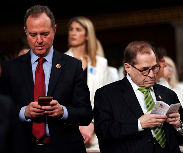 adam schiff works his phone while jerrold nadler reads the program for the state of the union