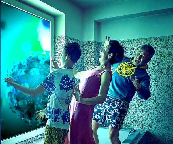 a mom dad and teen boy looking through and window and giant covid and being afraid