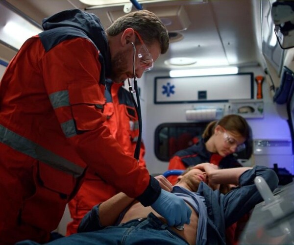 EMTs taking man out of ambulance at hospital