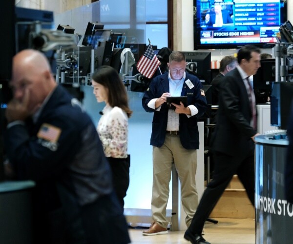 traders work on the floor at the stock exchange