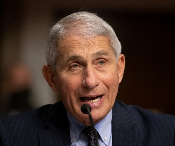 anthony fauci speaks into microphone