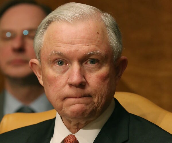 jeff sessions sits with a solemn expression