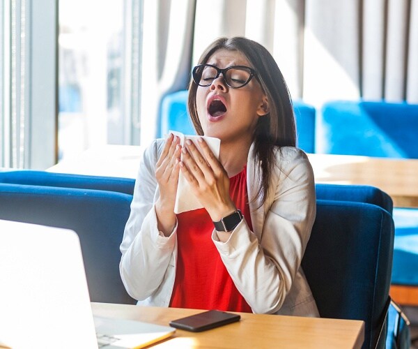 woman sneezing