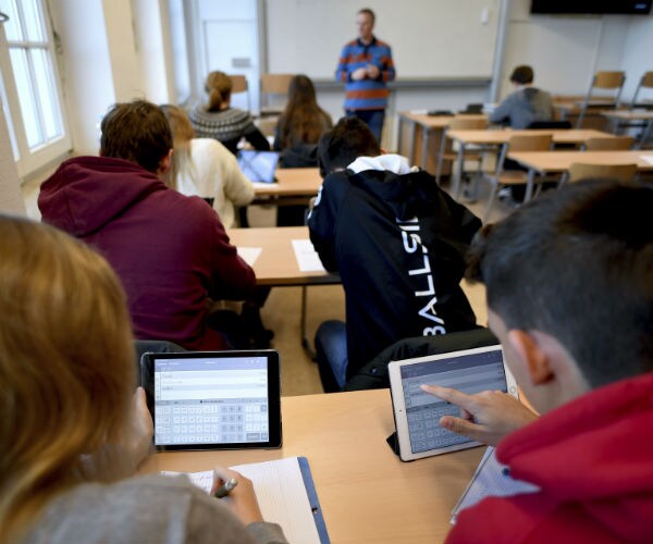 students in classroom using tablets