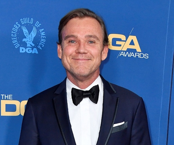 ricky schroder stands on red carpet