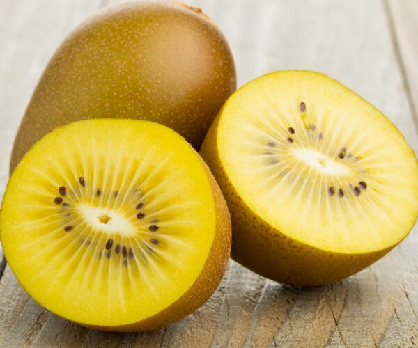 golden kiwis on a wooden cutting board
