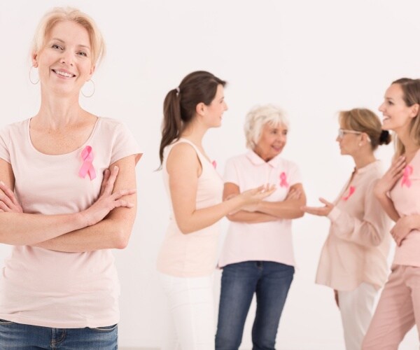 breast cancer survivors wearing pink shirts, ribbons