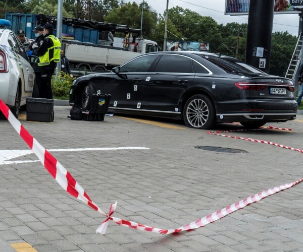 Police examine the car after an apparent assassination attempt