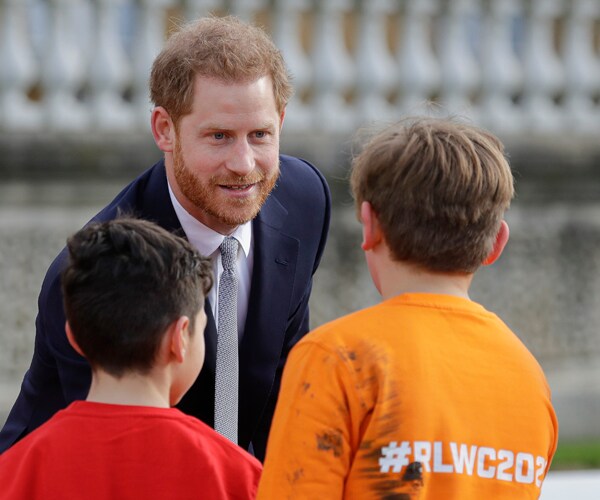 prince harry greets children at the gardens of buckingham palace