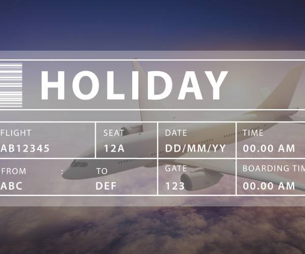 an airline boarding pass over a photo of a jetliner in flight