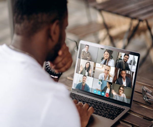 man on zoom call with six people