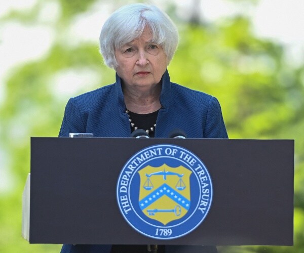 janet yellen speaks into a microphone